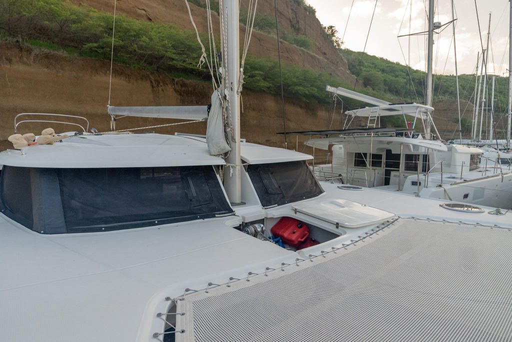 Interior saloon of the Fountaine Pajot Orana 44 showing light wood joinery and dark leather settee