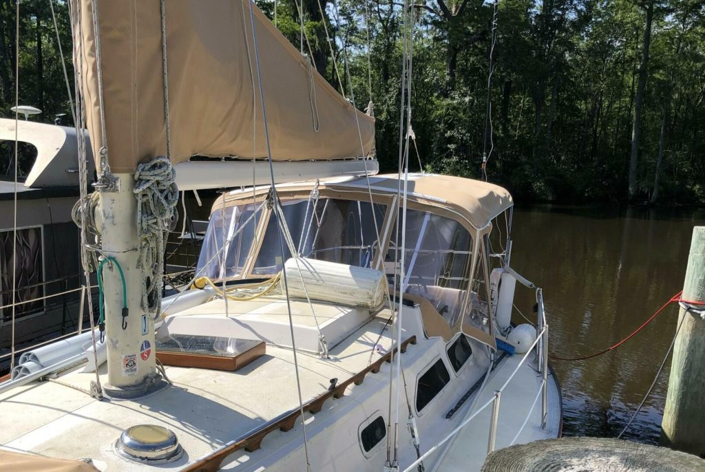 Interior main saloon of the Islander 36 with settee, teak joinery and light-filled cabin