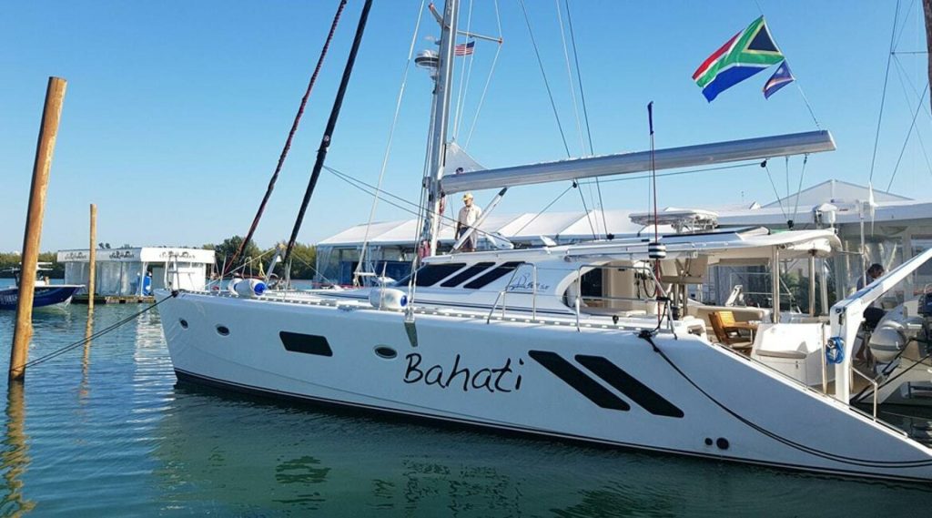 Knysna 500SE catamaran under sail, showing the low slanted-window profile and hard cockpit roof