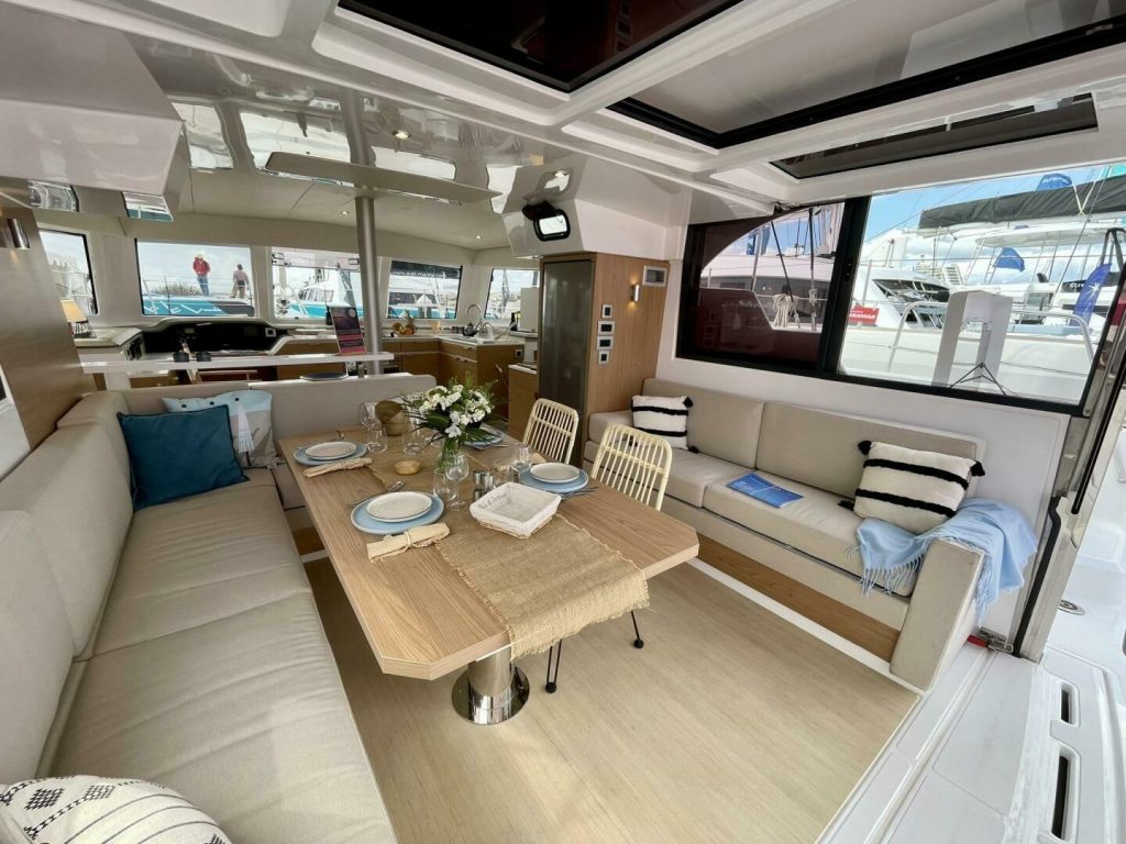 Open saloon and galley of the Bali 40 Catspace with dining table and large windows