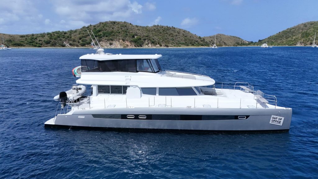 Voyage 650 PC Out Of Office underway, showing her twin hulls and expansive superstructure