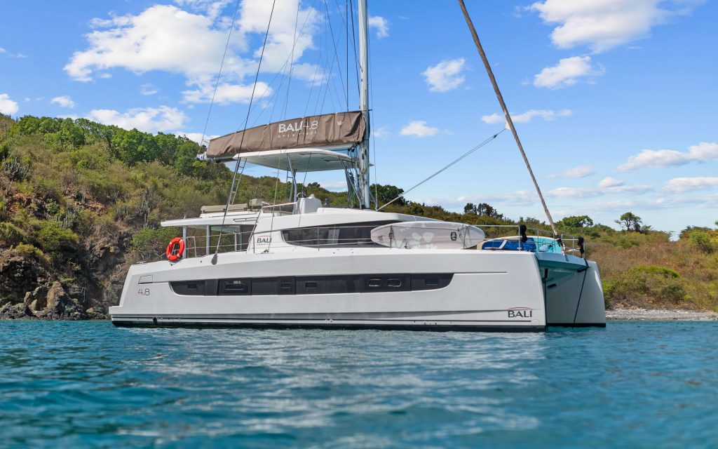 Bali 4.8 flybridge helm station with Raymarine electronics and hardtop shading the lounge area