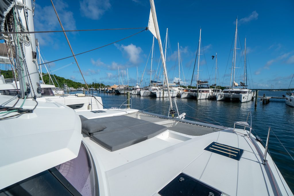 Interior salon and galley of the Fountaine Pajot Saona 47 with island countertop and L-shaped settee