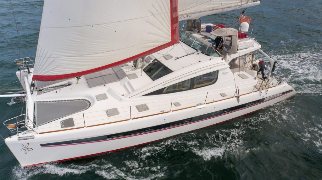 The Privilege 615 catamaran S/V Tehiya under way, showing her integrated flybridge and cruising rig