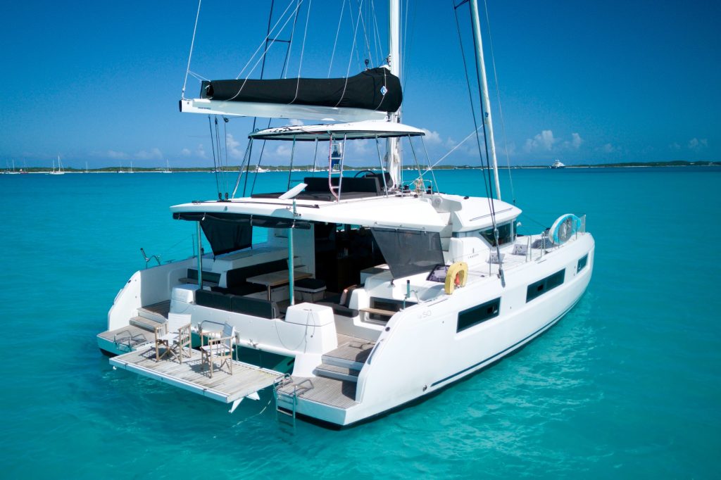 Overhead view of the Lagoon 50's cockpit, flybridge hardtop and hydraulic swim platform