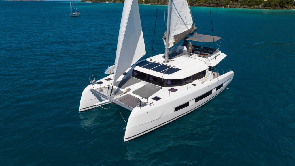 Main saloon and galley of the 2021 Dufour 48 Aquanimity showing teak sole and large windows