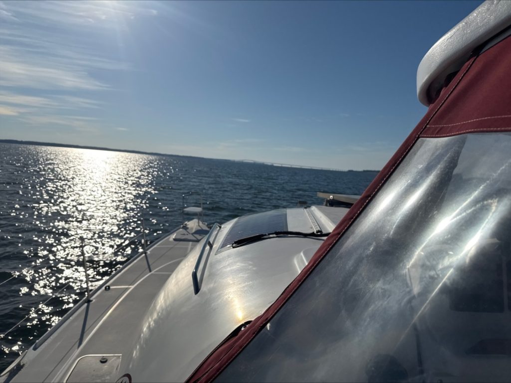 Lagoon 380 Custom PC M/Y Herkee at the dock showing her solar-covered coachroof and custom canvas enclosure