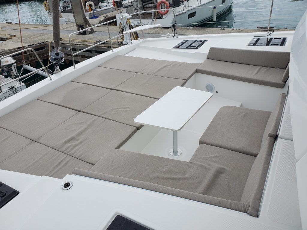 Saloon and galley of the 2023 Bali 4.4 Divine Destiny with L-shaped settee and open Bali door